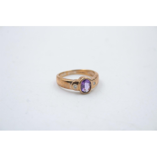 15 - A 9ct gold amethyst and diamond band ring - approx. gross weight 3.5 grams