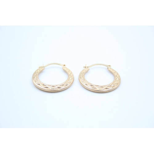 155 - A pair of 9ct gold Celtic design hoop earrings - approx. gross weight 1 gram