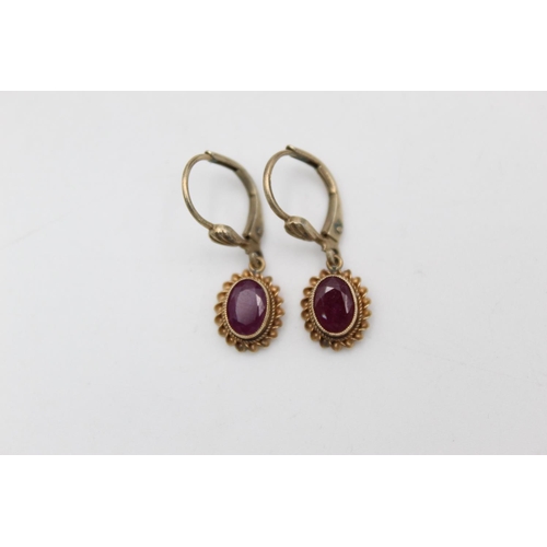 168 - A pair of 9ct gold framed ruby pendant earrings - approx. gross weight 2.1 grams