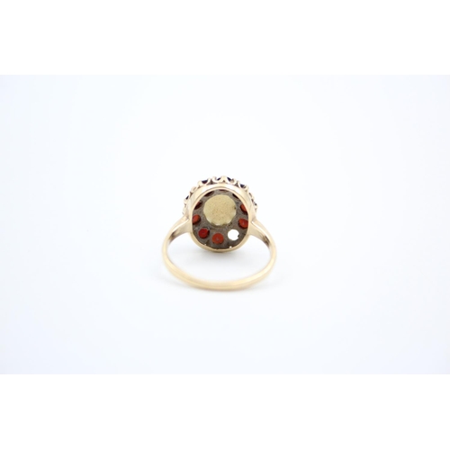 184 - A 9ct gold garnet and opal cluster ring - approx. gross weight 4 grams