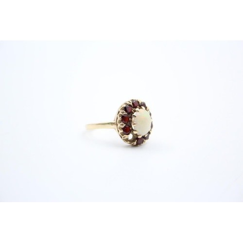 184 - A 9ct gold garnet and opal cluster ring - approx. gross weight 4 grams