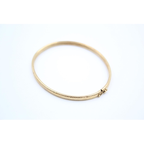 190 - A 9ct gold textured bangle - approx. gross weight 5.2 grams