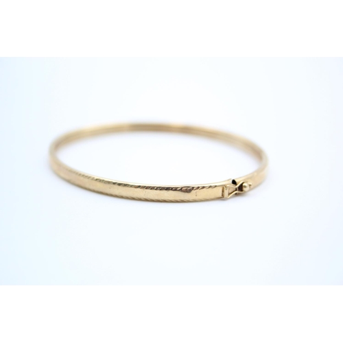 190 - A 9ct gold textured bangle - approx. gross weight 5.2 grams