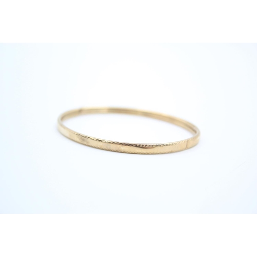 190 - A 9ct gold textured bangle - approx. gross weight 5.2 grams