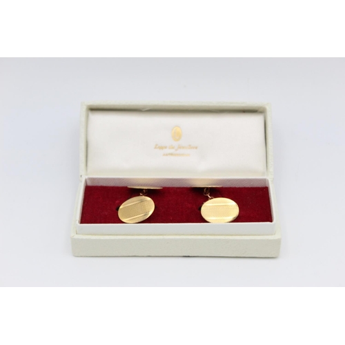 3 - A pair of boxed 9ct gold machine engraved cufflinks - approx. gross weight 3.3 grams