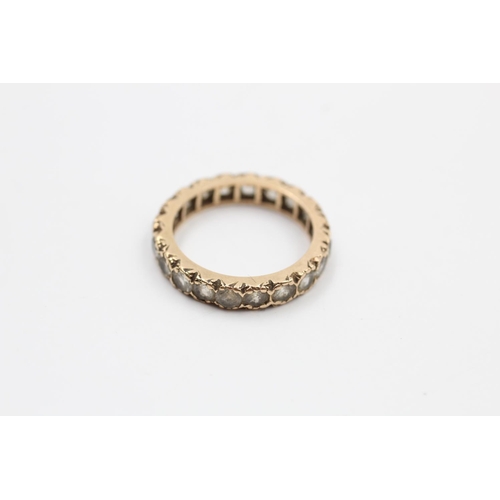49 - A 9ct gold gemstone full eternity ring - approx. gross weight 2.5 grams
