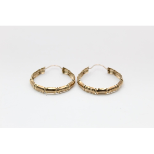 56 - A pair of 9ct gold bamboo hoop earrings - approx. gross weight 2.1 grams
