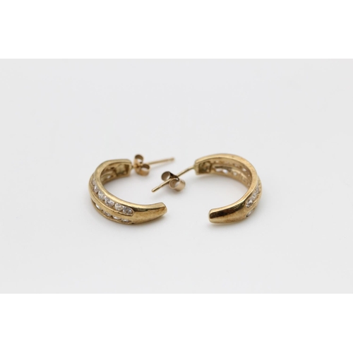 90 - A pair of 9ct gold gemstone channel set half hoop earrings - approx. gross weight 2.7 grams