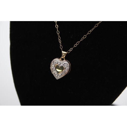 98 - A 9ct gold bicolour patterned heart locket pendant necklace - approx. gross weight 1.6 grams