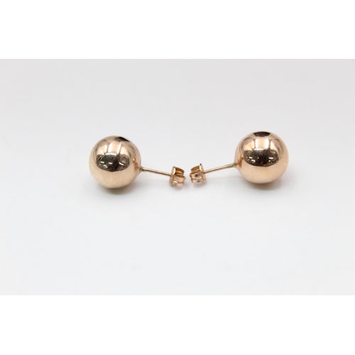 99 - A pair of 14ct gold large ball stud earrings - approx. gross weight 1.6 grams