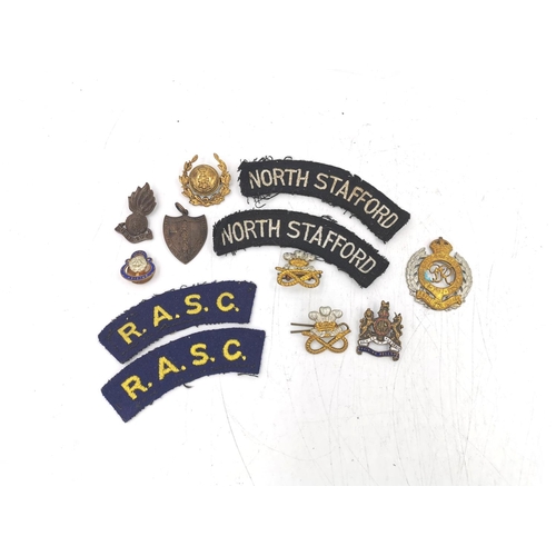 342 - A collection of various military badges and patches