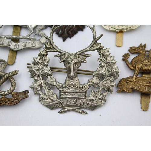 352 - Fifteen vintage military badges to include Scottish, South Staffs etc.