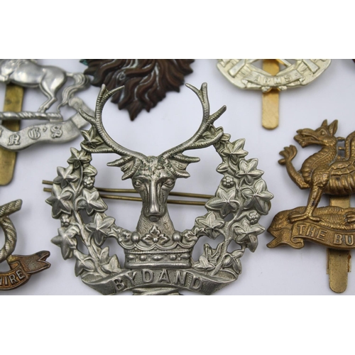 352 - Fifteen vintage military badges to include Scottish, South Staffs etc.