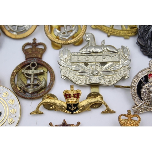 353 - Twenty four assorted military badges to include R.A.F, Submarines, Royal Marines etc.