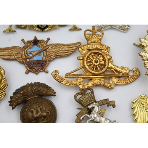 353 - Twenty four assorted military badges to include R.A.F, Submarines, Royal Marines etc.