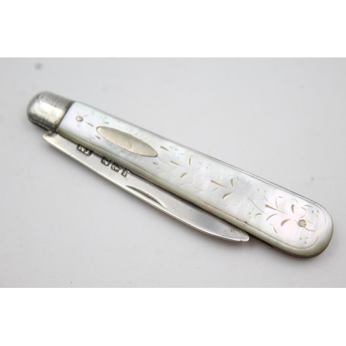 414 - Two hallmarked sterling silver and mother of pearl fruit knives - approx. gross weight 28 grams