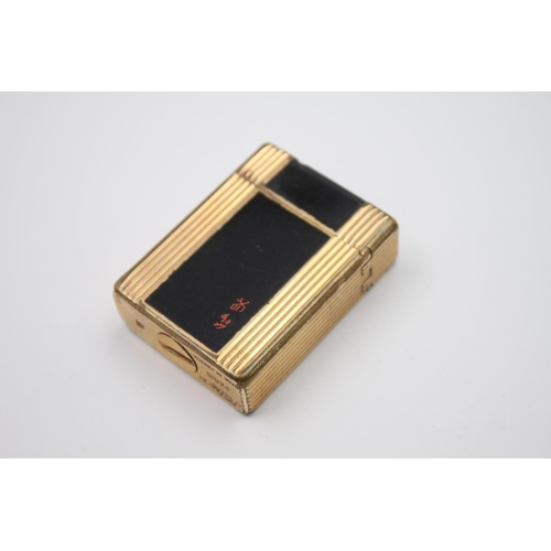 428 - A St. Dupont of Paris black lacquer and gold plated cigarette lighter - ref no. BT0222