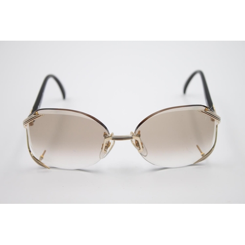 446 - A pair of Christian Dior style frameless sunglasses with pouch