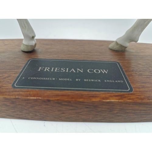 459 - A Beswick Friesian Cow Connoisseur model on wooden plinth - approx. 19cm high x 30cm long