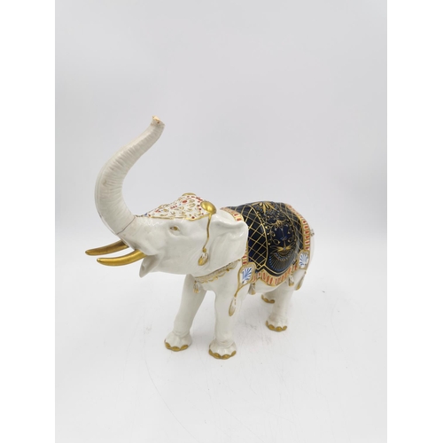 464A - A vintage German porcelain elephant figurine with 'S' makers mark to base - approx. 24cm high x 26cm... 