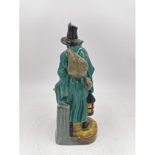 473A - A Royal Doulton 'The Mask Seller' figurine - HN 2103