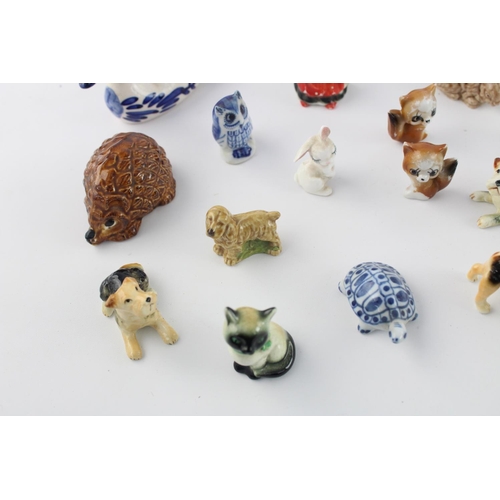 508 - A collection of assorted ceramic animal figurines to include Delft Ware duck, Wade Whimsies etc.