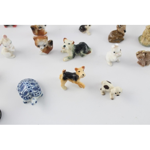 508 - A collection of assorted ceramic animal figurines to include Delft Ware duck, Wade Whimsies etc.