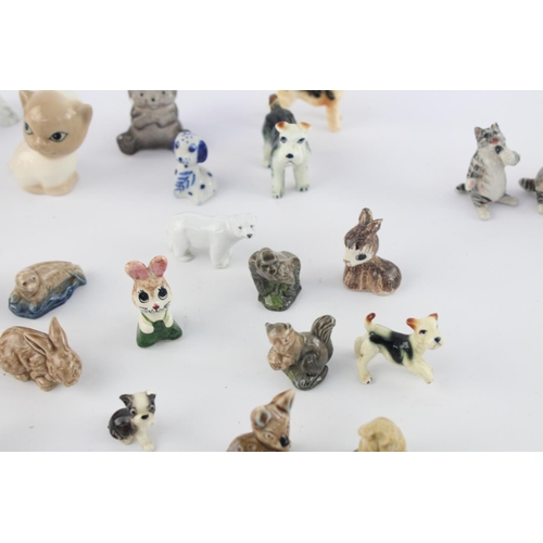 508 - A collection of assorted ceramic animal figurines to include Delft Ware duck, Wade Whimsies etc.