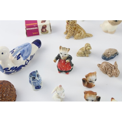 508 - A collection of assorted ceramic animal figurines to include Delft Ware duck, Wade Whimsies etc.