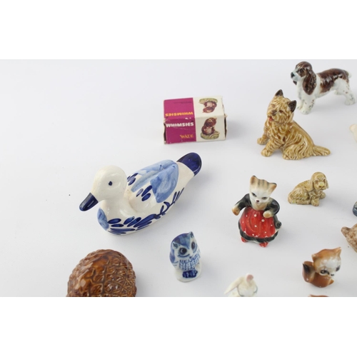 508 - A collection of assorted ceramic animal figurines to include Delft Ware duck, Wade Whimsies etc.