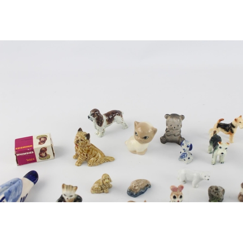 508 - A collection of assorted ceramic animal figurines to include Delft Ware duck, Wade Whimsies etc.