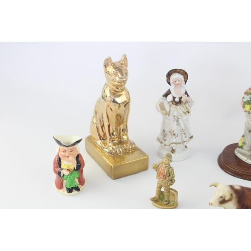 515 - A collection of assorted ceramic figurines to include Belleek, Wade Whimsies, Galos etc.