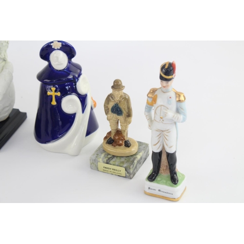 515 - A collection of assorted ceramic figurines to include Belleek, Wade Whimsies, Galos etc.