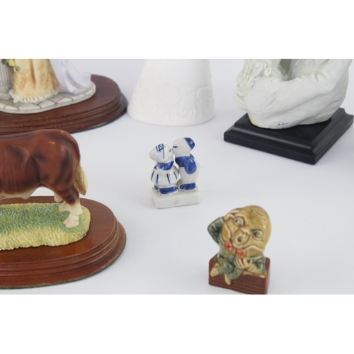 515 - A collection of assorted ceramic figurines to include Belleek, Wade Whimsies, Galos etc.