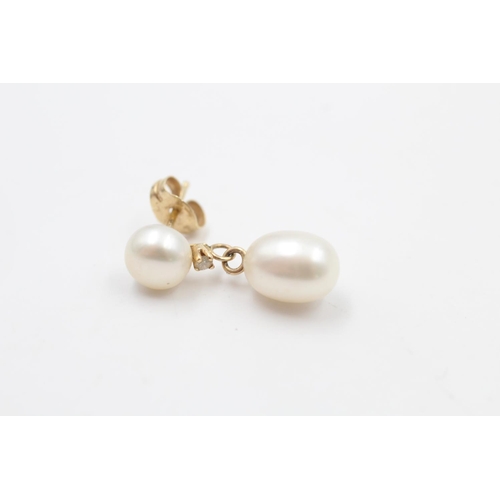 110 - A pair of 14ct gold pearl and diamond drop earrings - approx. gross weight 4.7 grams