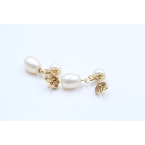 110 - A pair of 14ct gold pearl and diamond drop earrings - approx. gross weight 4.7 grams