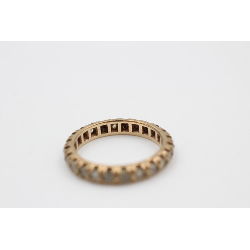 115 - A 9ct gold full eternity gemstone ring, size P ½ - approx. gross weight 3.3 grams