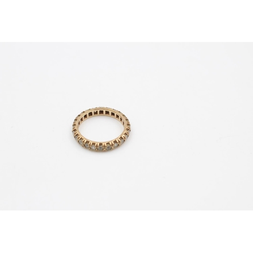 115 - A 9ct gold full eternity gemstone ring, size P ½ - approx. gross weight 3.3 grams