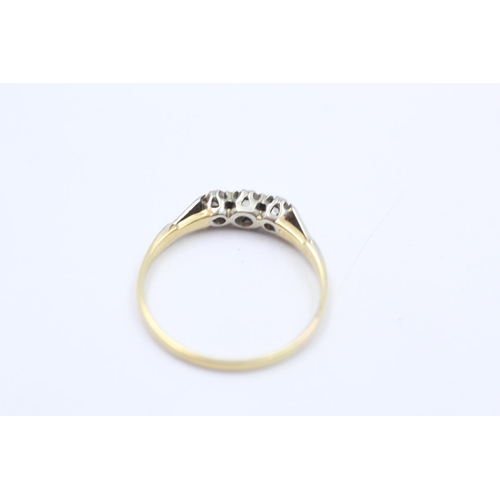 24 - An 18ct gold and platinum shouldered diamond trilogy ring, size R - approx. gross weight 1.8 grams