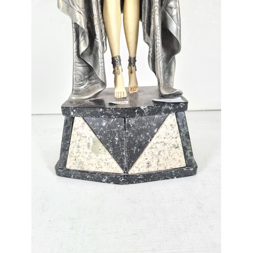 509 - An Art Deco style resin female figurine with pewter finish cloak on marble base - approx. 57cm high