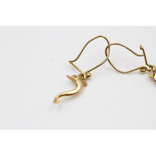 31 - A pair of 14ct gold dolphin wire hook drop earrings - approx. gross weight 1.8 grams