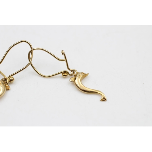 31 - A pair of 14ct gold dolphin wire hook drop earrings - approx. gross weight 1.8 grams