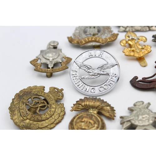 102 - Fifteen assorted vintage military cap badges to include Scottish, Suffolk, West Riding etc.