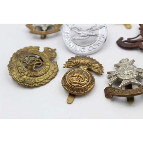 102 - Fifteen assorted vintage military cap badges to include Scottish, Suffolk, West Riding etc.