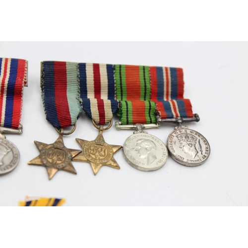 108 - A collection of miniature medals to include mounted WWII groups, National Service etc.