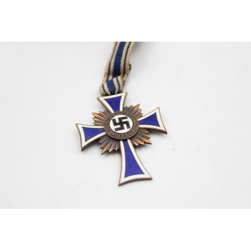 110 - A WWII German bronze Mother's Cross with ribbon and enamel N.S. Arbeitsdienst badge