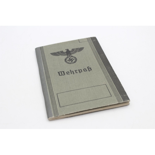 118 - Three various German military items, WWII .925 silver Wound badge, Wehrpass documentation book and W... 