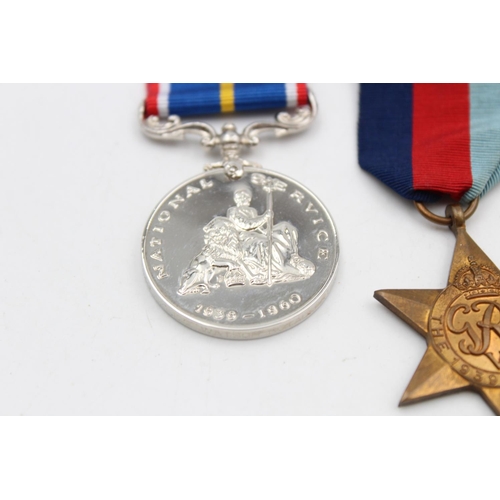 129 - Four assorted medals, three WWII mounted medals comprising The 1939-1945 Star, The Africa Star and T... 