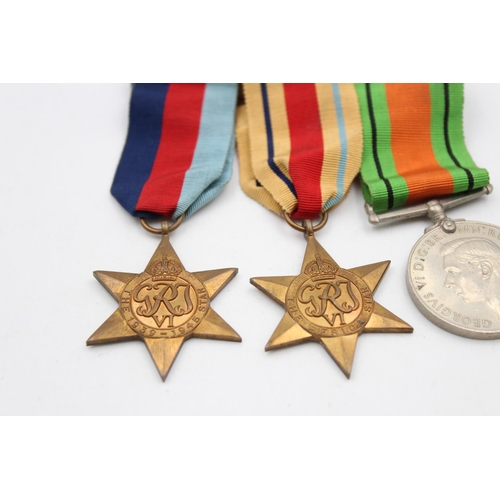 129 - Four assorted medals, three WWII mounted medals comprising The 1939-1945 Star, The Africa Star and T... 