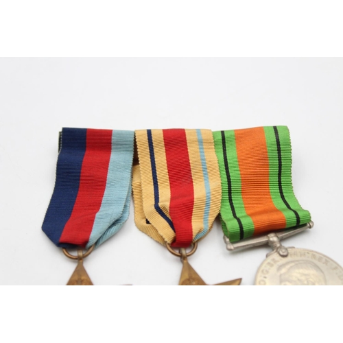 129 - Four assorted medals, three WWII mounted medals comprising The 1939-1945 Star, The Africa Star and T... 